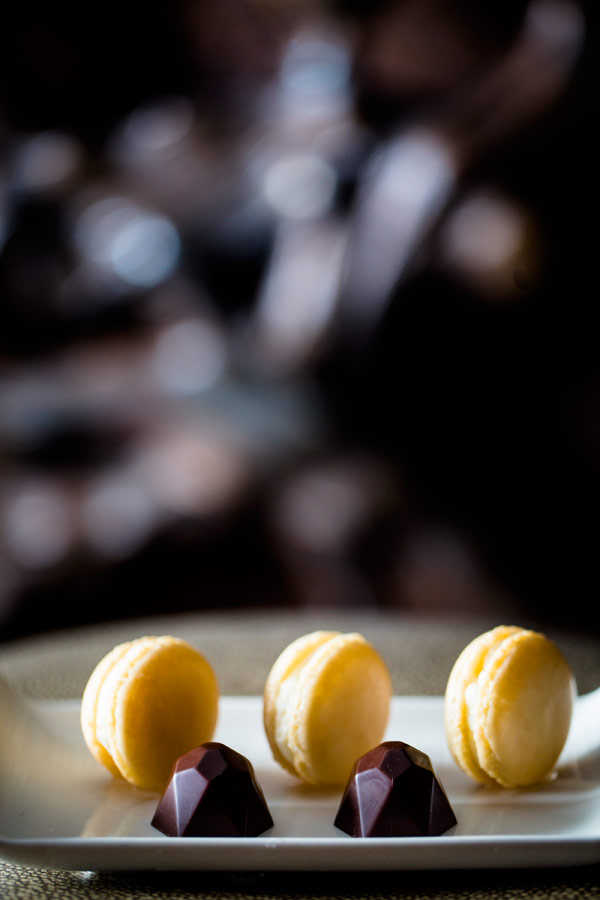 Macarons and chocolates on a marble counter