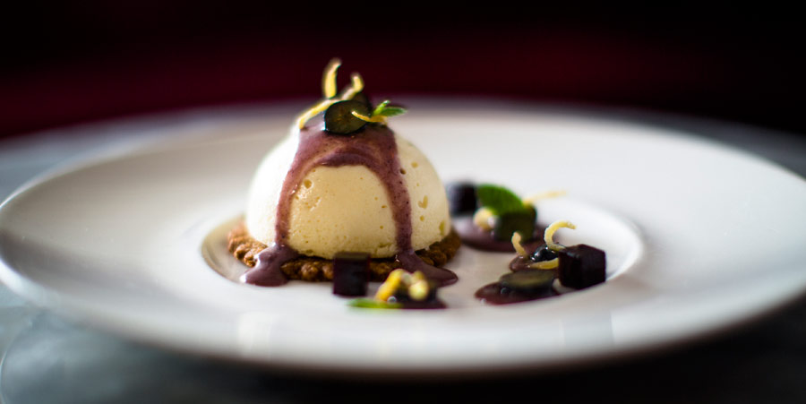 A panna cotta dessert with pistachio and chocolate