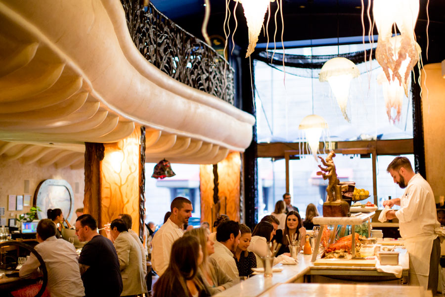Jellyfish chandeliers glowing above the Farallon lounge